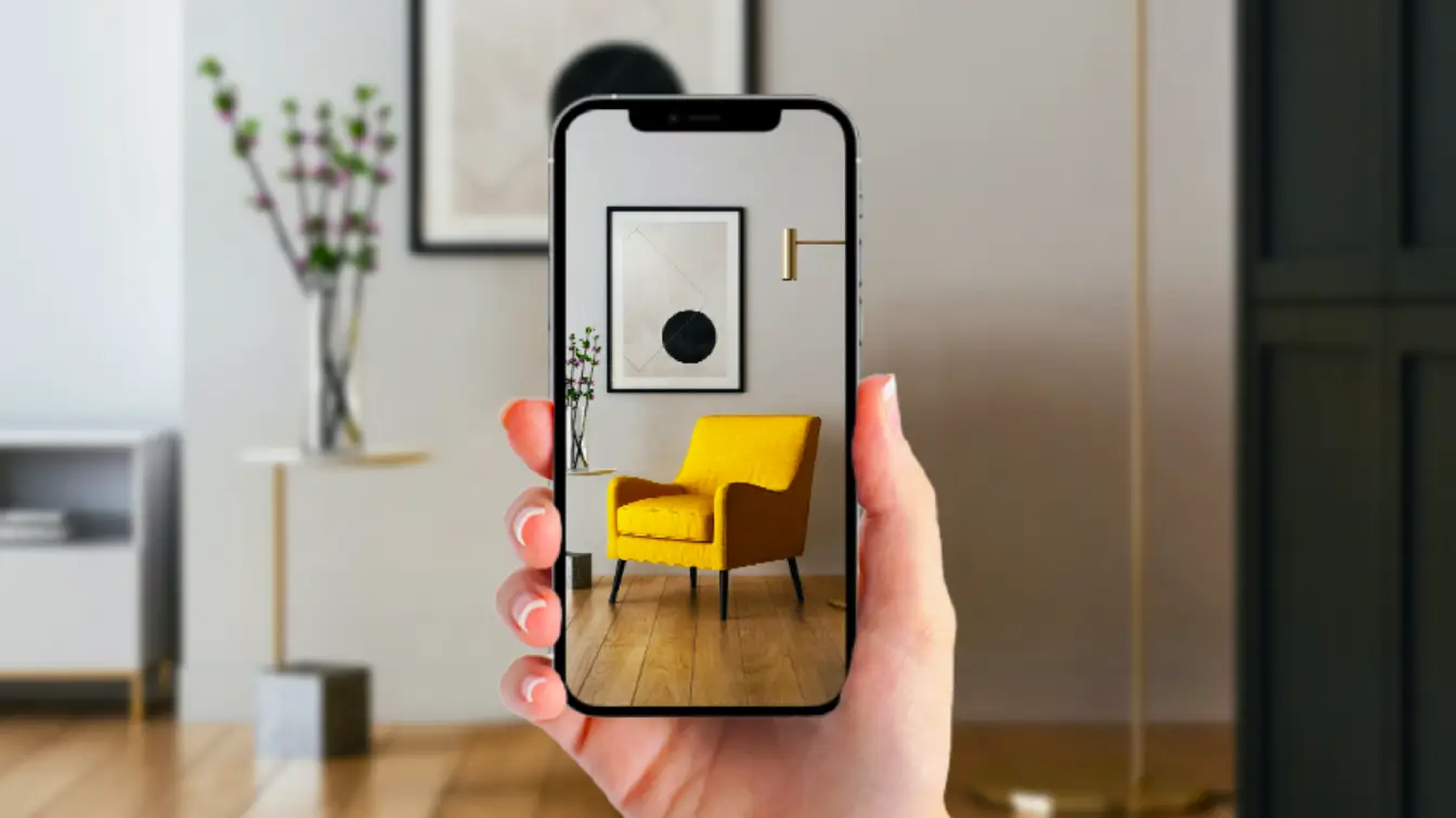 A womans hand holding a phone with an augmented reality hologram of a yellow chair on the screen
