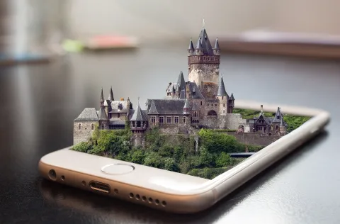 Augmented reality castle sitting ontop of a mobile phone on a table