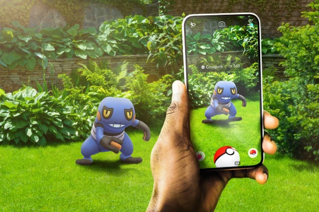 Play Genesis Augmented Reality Games. Person using a pokeball to catch a Croagunk in the Pokemon GO augmented reality game.