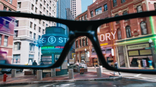 first person view through a pair of AR glasses showing a city overlayed with augmented reality content