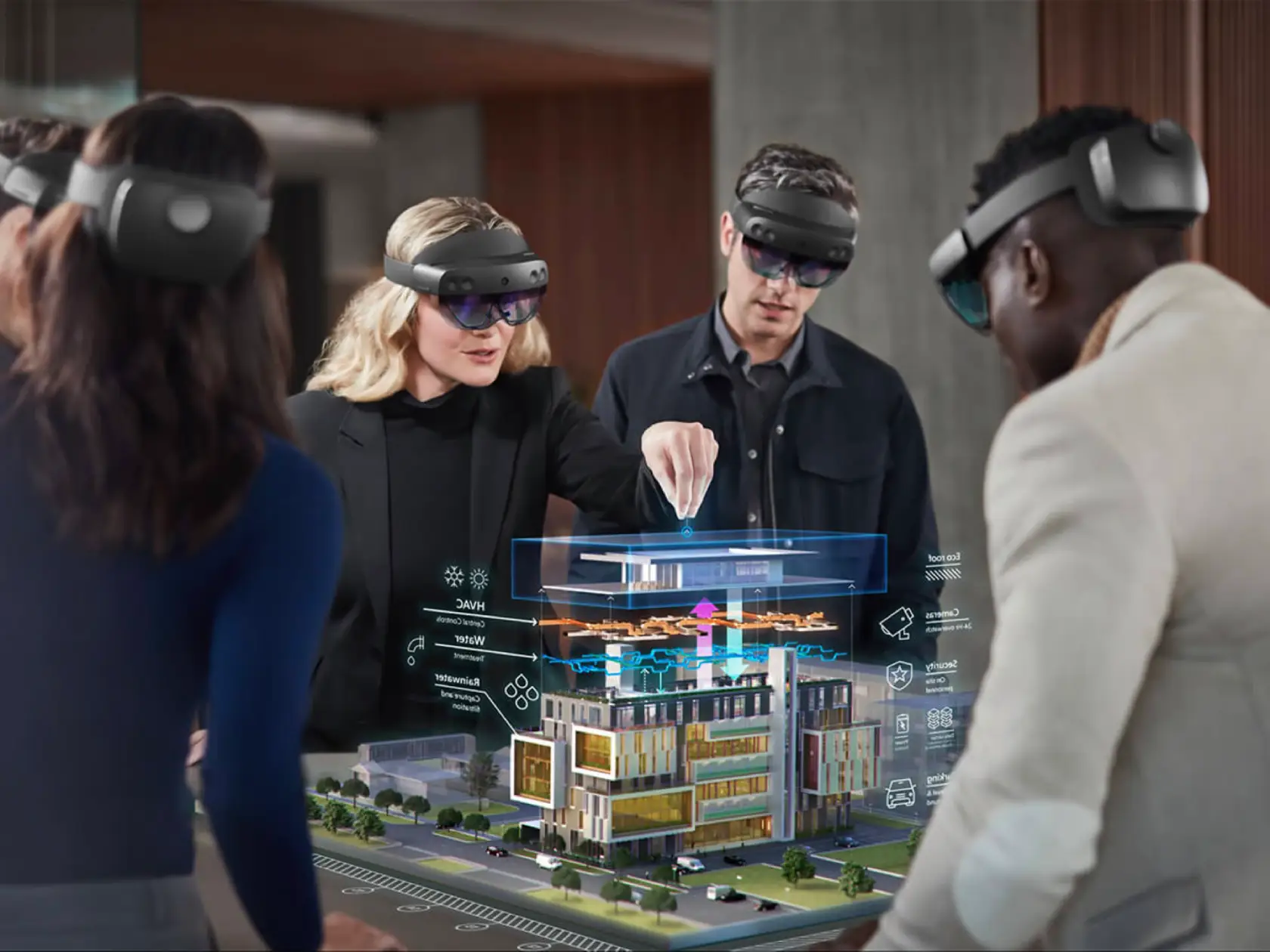 Group of people wearing black augmented reality headsets standing around a augmented reality real estate showcase