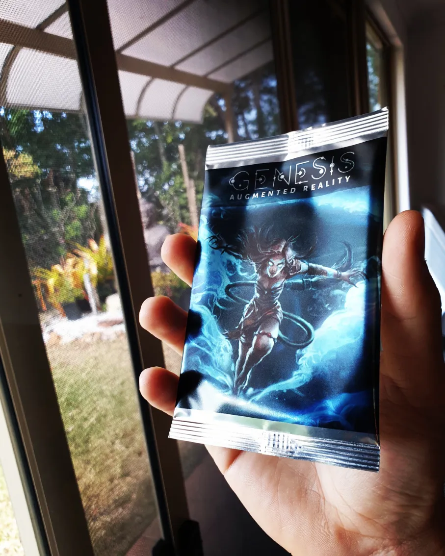 A booster pack filled with three Genesis Augmented Reality Trading Cards